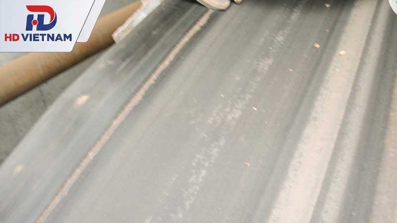 Bụi bẩn hoặc vật liệu bám dính trên rulo, con lăn